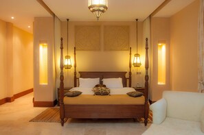 A four-poster bed with a wooden headboard, two wall-mounted lamps, and a chandelier. - Sun Africa Beach Resort (Mombasa)