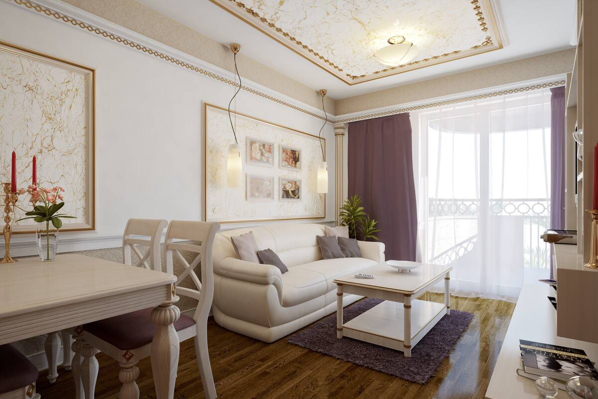 A living room with a white sofa, a coffee table, a dining table with chairs, and a chandelier.