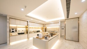 A modern kitchen with a central island, built-in appliances, and a sleek design. - Ji Hotel Beijing Guomao (Beijing)