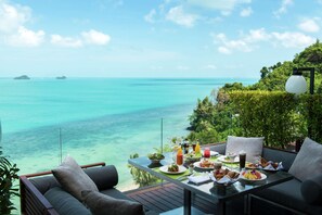 A dining table with breakfast items and a view of the ocean. - Conrad Koh Samui Resid (Koh Samui)