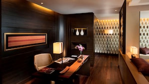 A modern hotel lobby with a reception desk, seating area, and decorative wall panels. - Conrad Koh Samui Resid (Koh Samui)