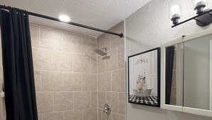A bathroom with a bathtub, toilet, and sink.