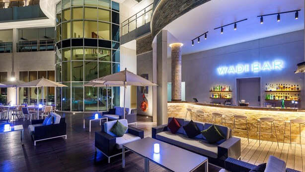A modern bar area with seating and a bar counter.