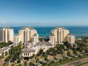 A high-rise hotel complex with multiple buildings, a beachfront view, and a well-maintained landscape with palm trees.
