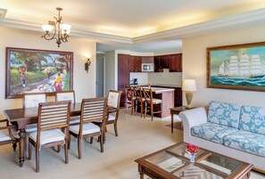 A spacious living area with a dining set, a sofa, and a kitchen in the background. - Jewel Grande Montego Bay Resort&spa (Montego Bay)