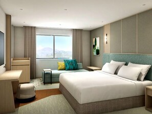 A modern hotel room with a large bed, a desk, a small seating area, and a window with a view. - ANA Holiday Inn Resort Karuizawa by IHG (Naganohara)