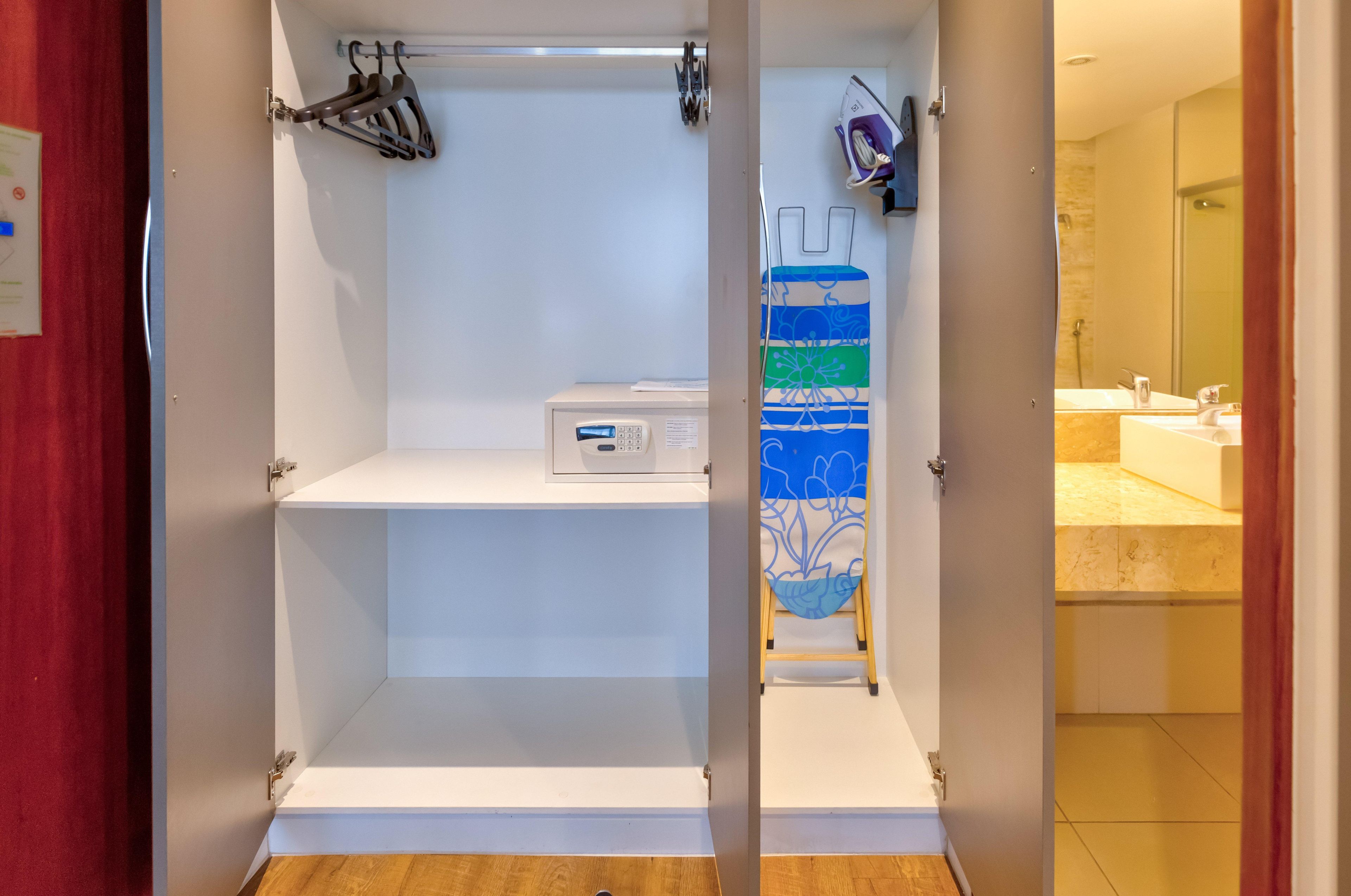 A bathroom with a shower, a toilet, and a sink.