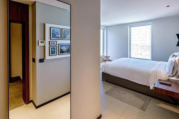 A modern hotel room with a bed, a large window, and wall-mounted artwork. - Form Hotel Dubai (Dubai)