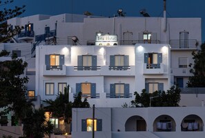A hotel with multiple balconies, a sign reading "Iris Hotel," and several windows with shutters. - Iris Boutique Hotel (Paros)