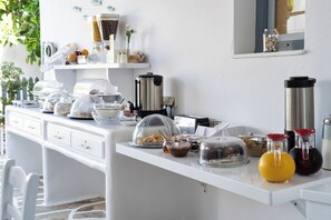 A breakfast buffet with various food items and condiments. - Iris Boutique Hotel (Paros)