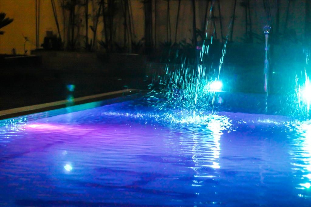 A pool with water jets and reflections.