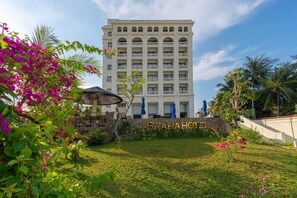 A hotel with a sign reading 'PRAHAHOTEL,' surrounded by lush greenery and palm trees. - Praha Hotel Phu Quoc (Phu Quoc)
