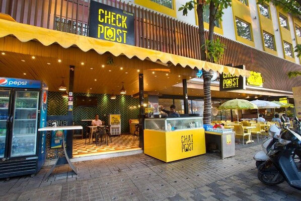 A check post with a yellow awning, a Pepsi refrigerator, and a motorcycle parked outside. - Fountain Tree by TGI - JP Nagar, Bangalore (Bengaluru)