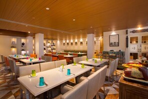 A restaurant with multiple tables and booths, wooden ceiling, and various wall decorations. - Fountain Tree by TGI - JP Nagar, Bangalore (Bengaluru)