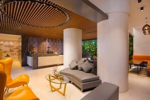 A modern lobby with a reception desk, a sofa, and a coffee table. - Fountain Tree by TGI - JP Nagar, Bangalore (Bengaluru)