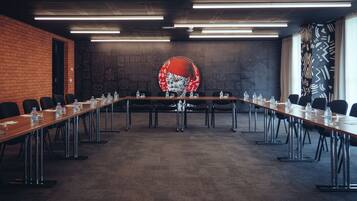 A conference room with a long table, chairs, and water bottles.
