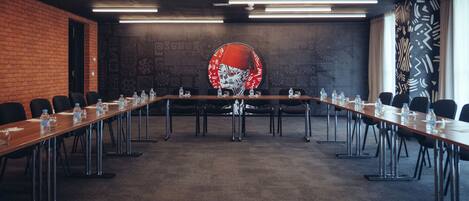 A conference room with a long table, chairs, and water bottles.
