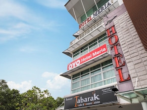 A hotel with a prominent sign for 'Hotel Meria' and a restaurant named 'Tabarak Arabic & Western Cuisine' below it.