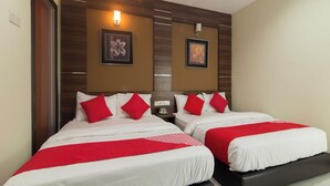 A hotel room with two beds, each with red and white bedding, wooden headboard panels, and wall-mounted light fixtures. - Super OYO Capital O 812 Hotel SMC Seksyen 13 (Shah Alam)