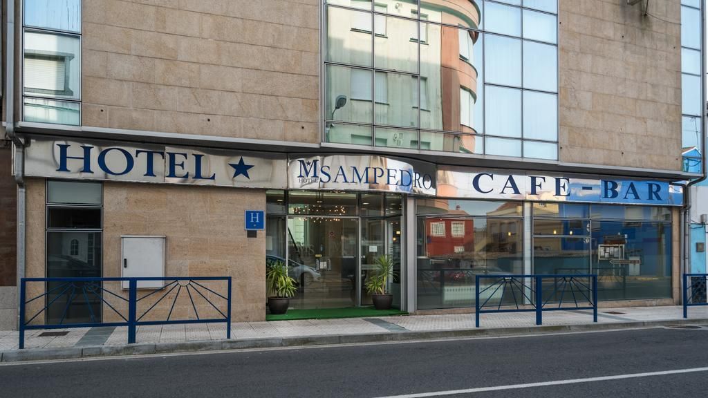 A building with a sign for a hotel and a cafe-bar.