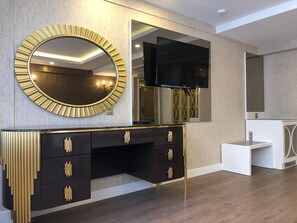 A modern bathroom with a vanity, a large mirror, and a television. - Burj Al Istanbul (Istanbul)