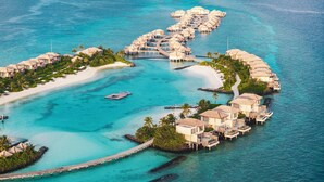 An overwater resort with multiple bungalow-style accommodations connected by walkways. - Intercontinental Maldives Maamunagau Resort (Maamunagau Island)