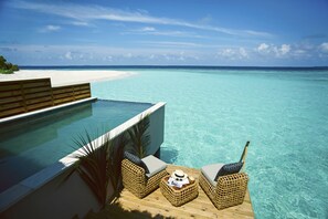 A poolside area with a view of a beach and ocean. - Kudafushi Resort & Spa (Kudafushi)