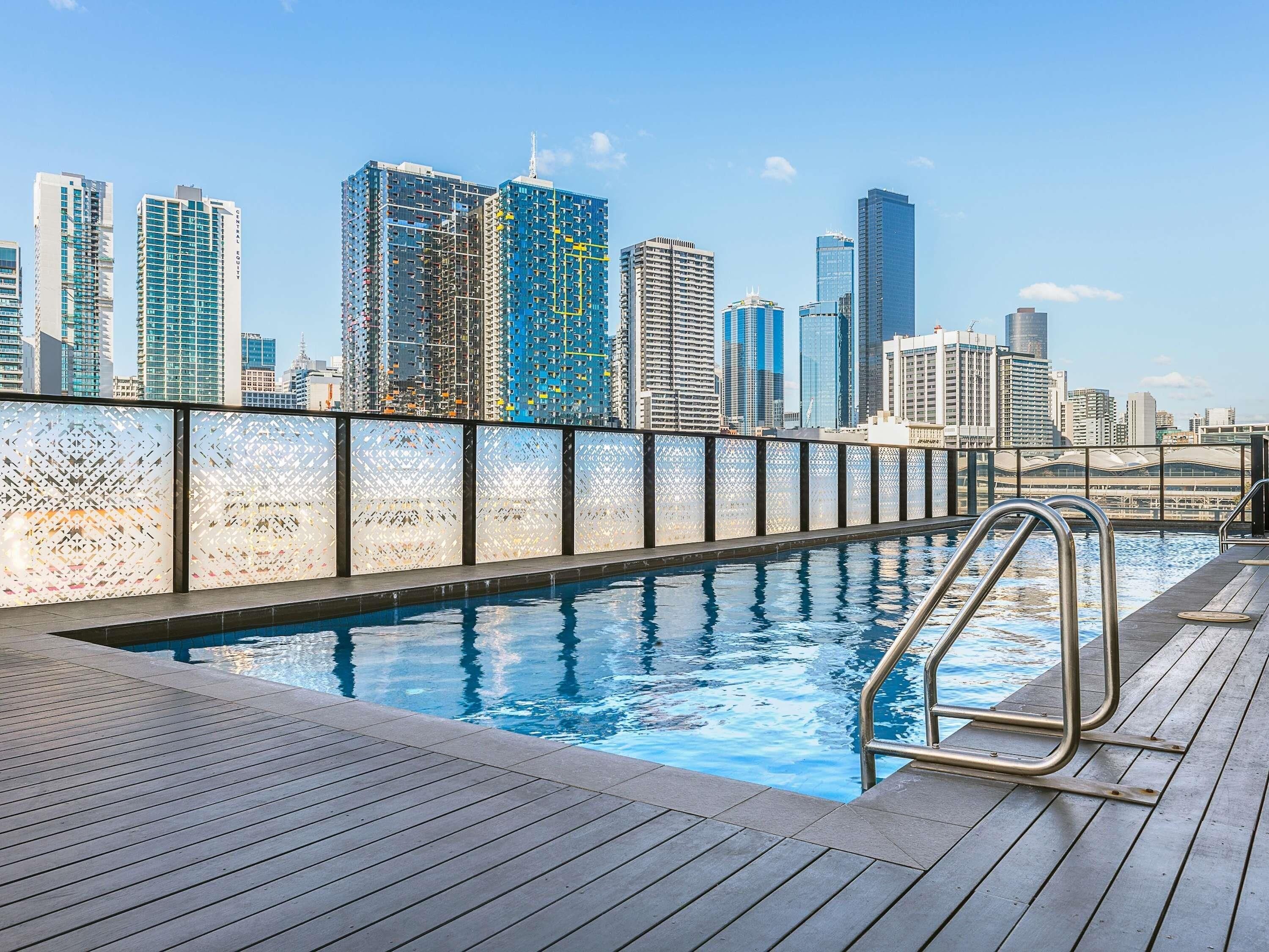 A rooftop pool with a city skyline in the background.