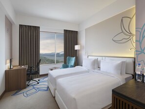 A hotel room with two beds, a desk, a chair, a lamp, and a view of the landscape. - Mercure Chennai Sriperumbudur (Tirukalukundram)