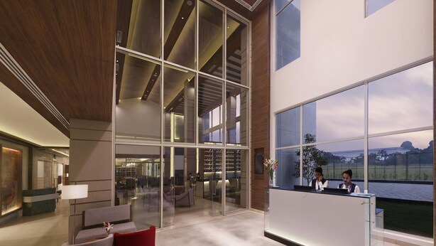 A spacious lobby with a reception desk, large windows, and a modern interior design. - Mercure Chennai Sriperumbudur (Tirukalukundram)