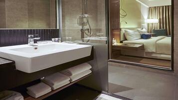 A modern bathroom with a sink, mirror, and shower.