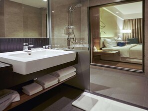 A modern bathroom with a sink, mirror, and shower. - Mercure Chennai Sriperumbudur (Tirukalukundram)