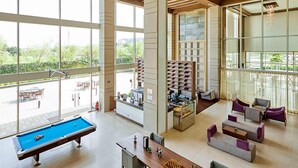 A spacious indoor area with a pool table, seating, and a view of the outdoors. - Mercure Chennai Sriperumbudur (Tirukalukundram)