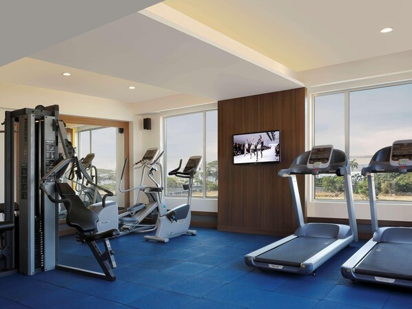 A gym with treadmills, elliptical machines, and weight equipment. - Mercure Chennai Sriperumbudur (Tirukalukundram)