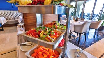 A buffet with various fruits and vegetables.