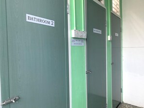 A set of three doors labeled 'Bathroom 2,' 'Bathroom 3,' and 'Bathroom 4,' with a sign indicating 'Water Light Water Heater Switch Off After Use.' - Spot ON 89872 Kuantan Backpackers (Kuantan)