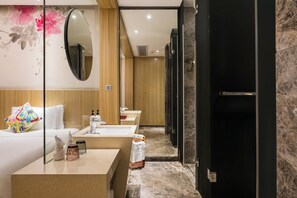 A modern bathroom with a wooden vanity, a large mirror, and a shower area. - Paco Hotel Taojin Metro Guangzhou (Guangzhou)