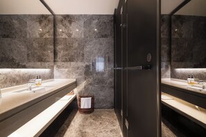 A modern bathroom with two sinks, marble walls, and a large mirror. - Paco Hotel Taojin Metro Guangzhou (Guangzhou)