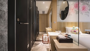 A modern bathroom with a large mirror, a sink, a toilet, and a shower area. - Paco Hotel Taojin Metro Guangzhou (Guangzhou)