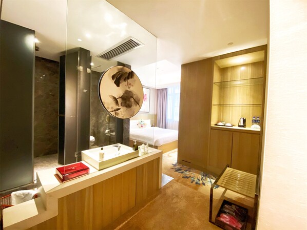 A modern bathroom with a large mirror, a sink, and a shower area. - Paco Hotel Taojin Metro Guangzhou (Guangzhou)
