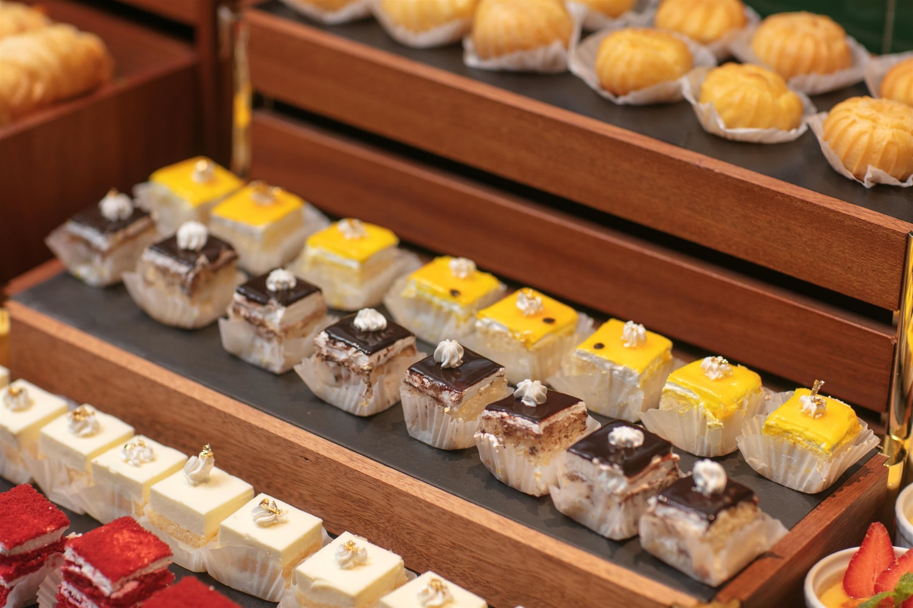 A variety of desserts on display, including cakes and pastries.