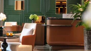 A modern interior with a reception desk, seating area, and decorative elements.