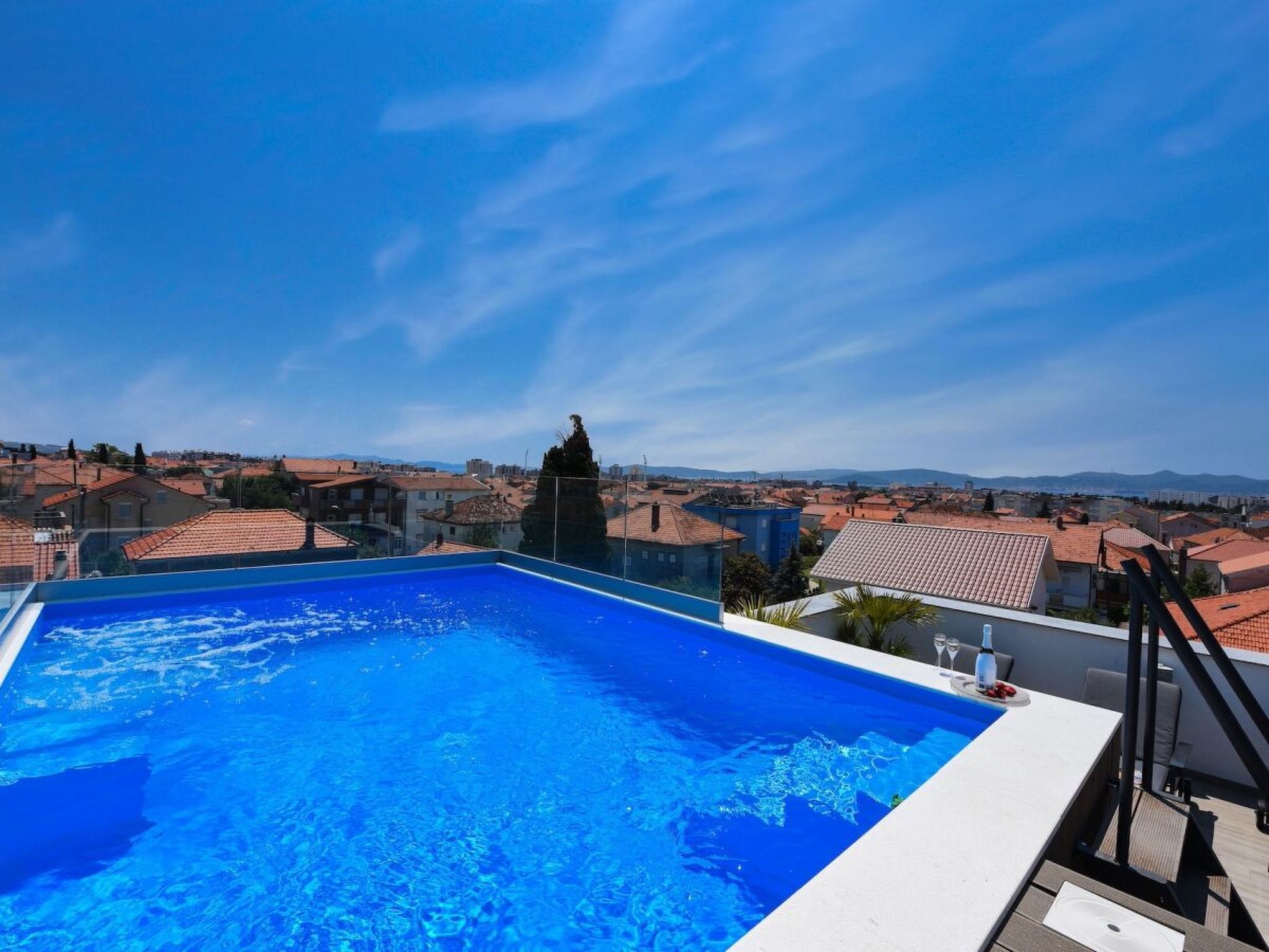 A rooftop pool with a clear view of the surrounding cityscape.