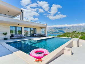 A modern outdoor swimming pool with a view of a mountainous landscape. - Villa Zariva with pool and panoramic mountain and by Interhome (Vinjerac)