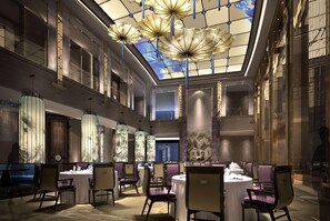 A spacious indoor area with multiple round tables and chairs, a high ceiling with a skylight, and decorative elements. - Wyndham Grand Foshan Gaoming (Foshan)