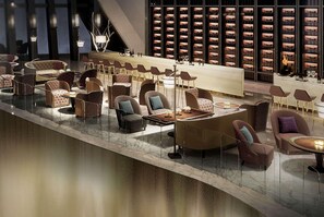 A modern lounge area with seating arrangements, a bar, and a wine display. - Wyndham Grand Foshan Gaoming (Foshan)