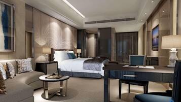 A modern hotel room with a bed, a desk, a sofa, and a TV.