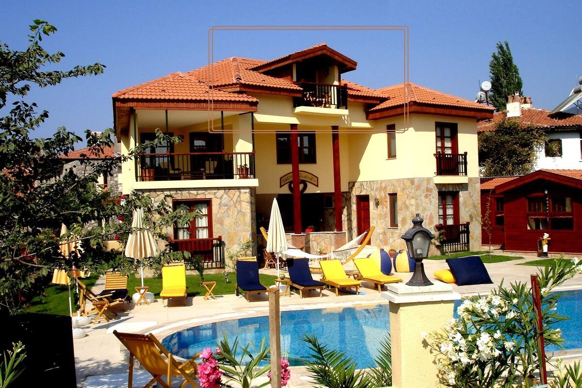 Ein Hotel mit Pool, mehreren Balkonen und Außenbereichen zum Sitzen.