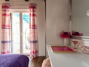 A room with a bed, a vanity with a mirror, and a view through a door. - Villa Jurenda with heated pool by Interhome (Debeljak)