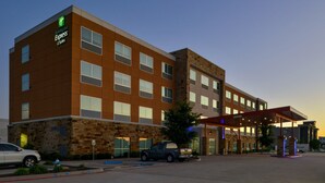A Holiday Inn Express hotel with a stone facade, multiple windows, and a covered entrance. - Holiday Inn Express and Suites Wylie West (Wylie)